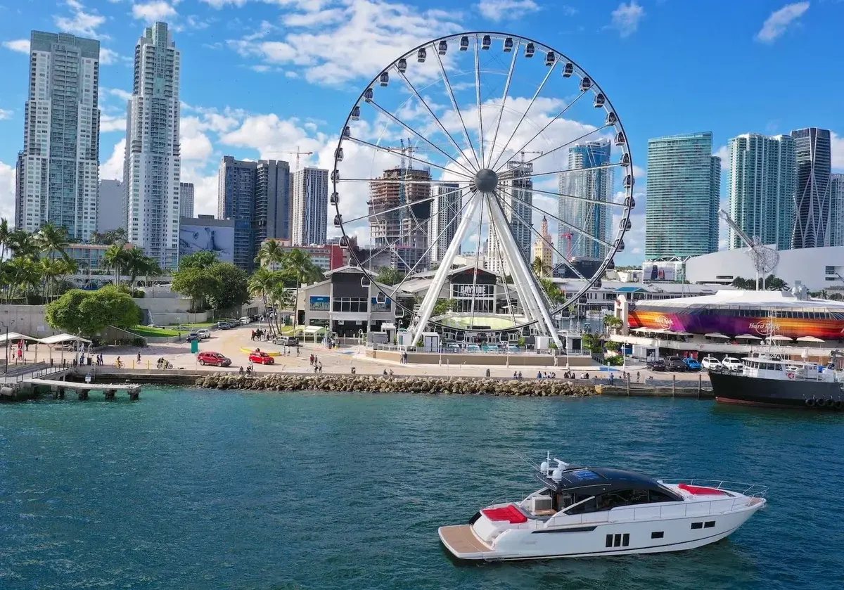 Yacht at Bayside Marina in Downtown Miami with the skyline and observation wheel behind