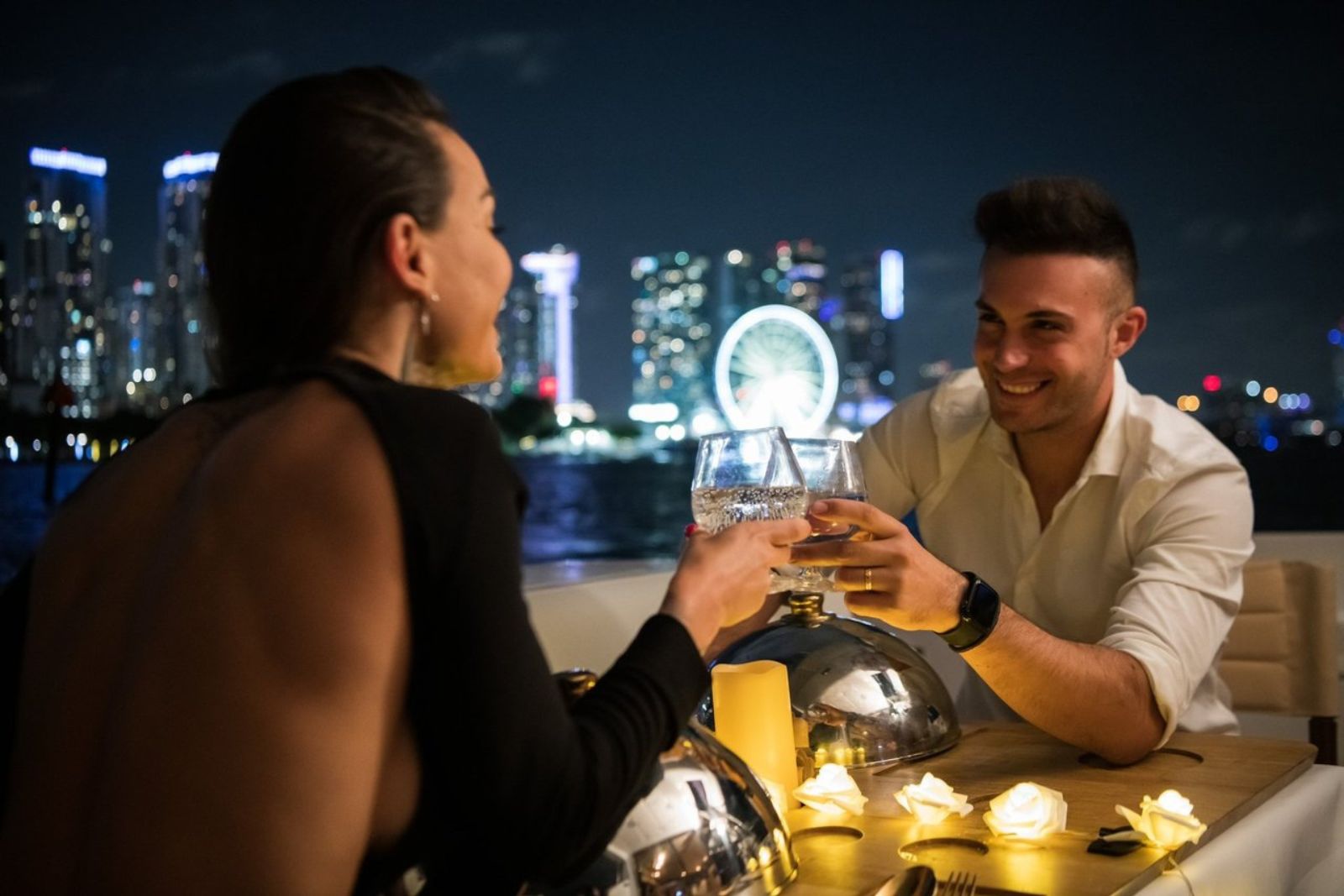 Date Night — couple toasting with Miami nightline view