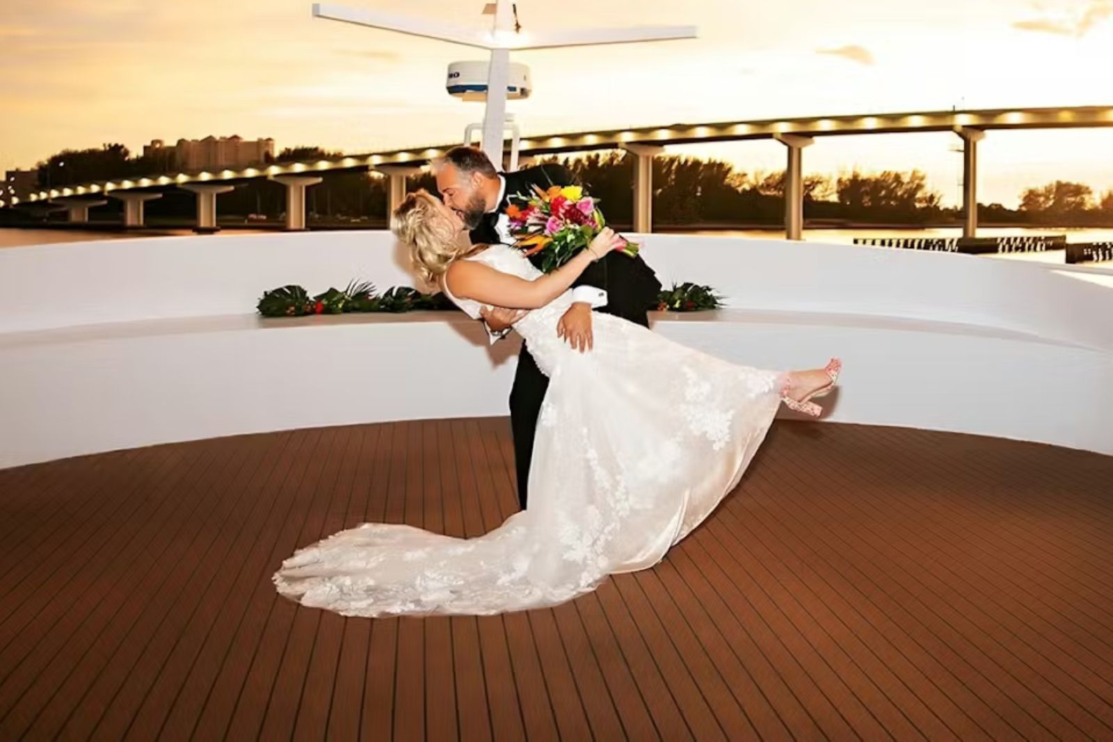 Yacht Wedding — bride and groom on deck at sunset