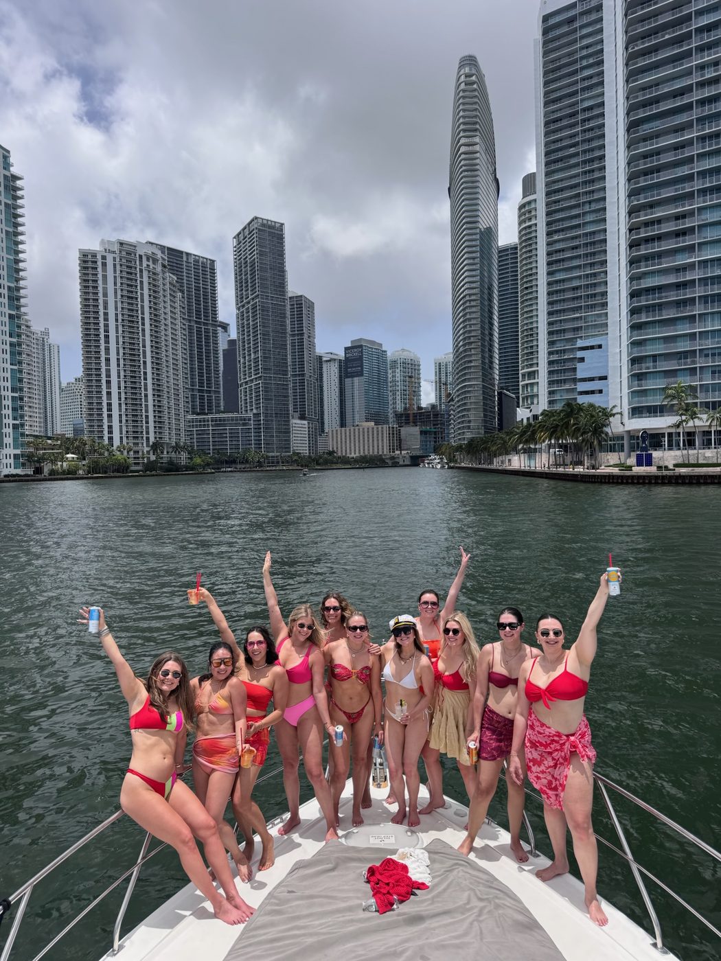 Bachelorette group on the bow of a yacht with the Brickell skyline behind them