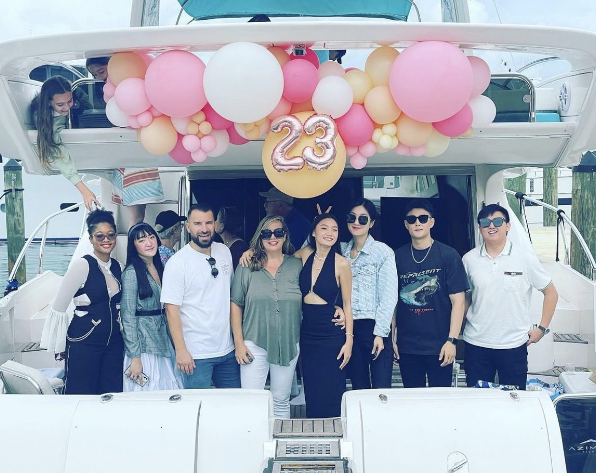 Birthday group celebrating on the back of a yacht in Miami with balloon decorations