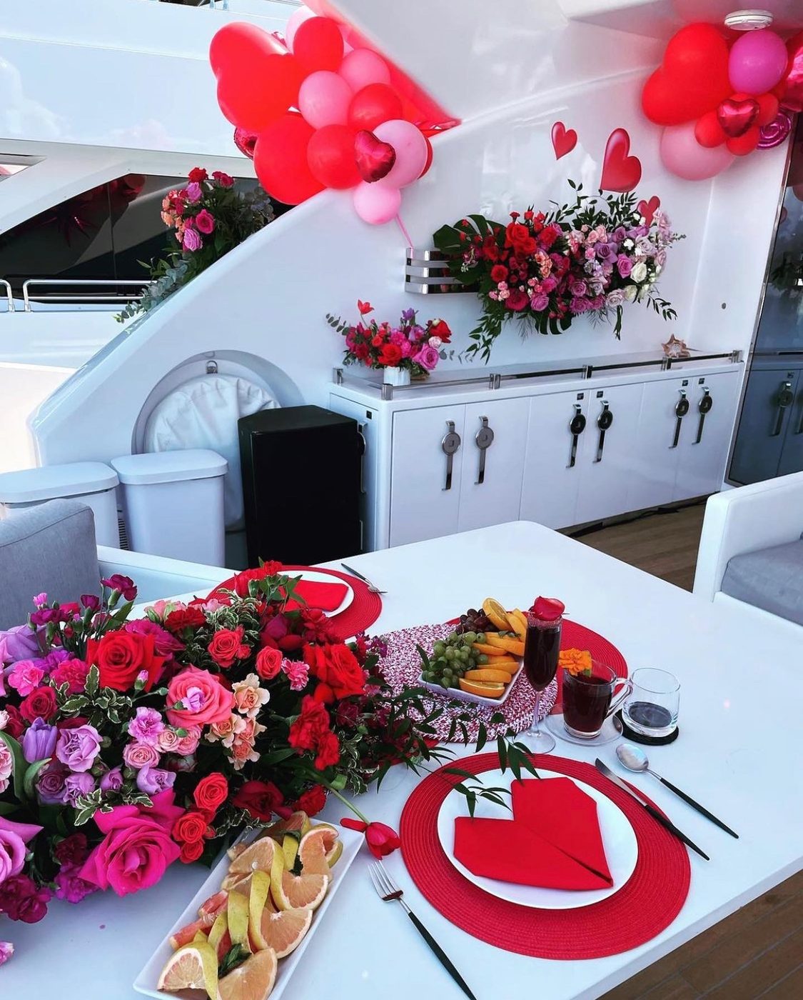Birthday table setting with flowers and balloons on a yacht aft deck in Miami